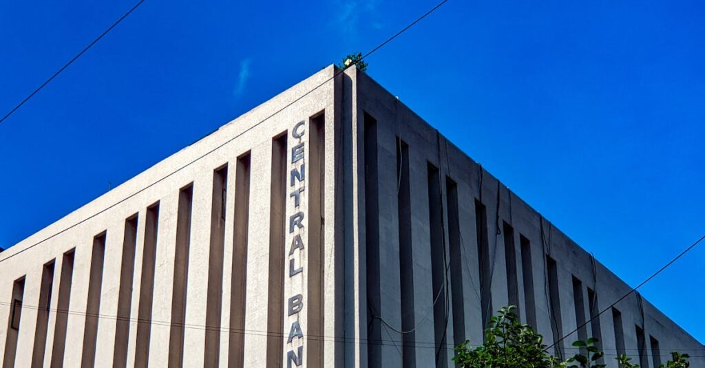 Geometric architecture of Central Bank of India against a bright blue sky.